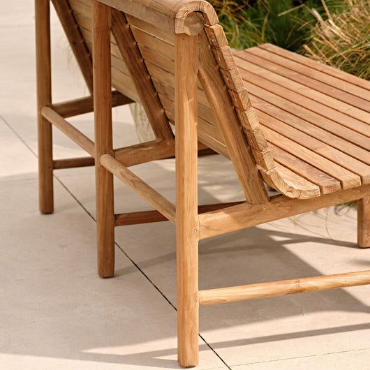 Wooden outdoor lounge chair on a patio
